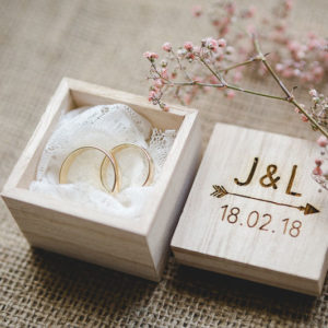 Wedding rings in wooden box with laser engraving